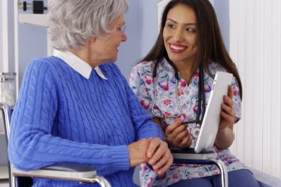 elderly woman in a wheelchair with her caregiver