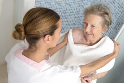 elderly woman taking a bath with her caregiver
